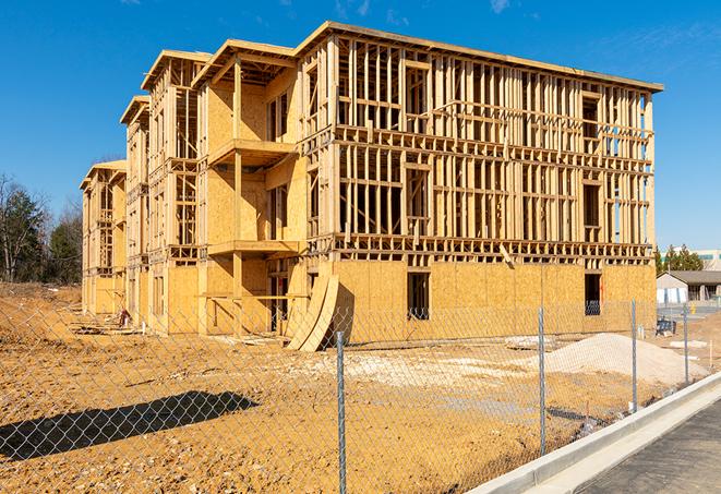 a close-up of temporary chain link fences enclosing a construction site, signaling progress in the project's development in Norwell, MA